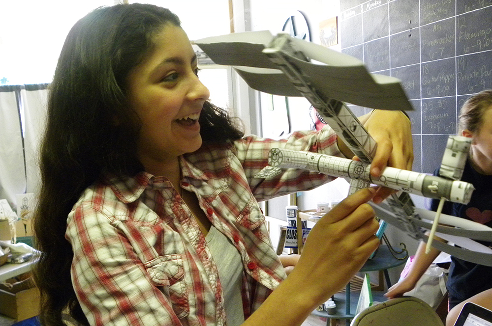Wichita Falls 4-H ZR student holds model of ISS